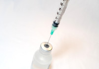针syringe with a vaccine bottle. Credit NIH